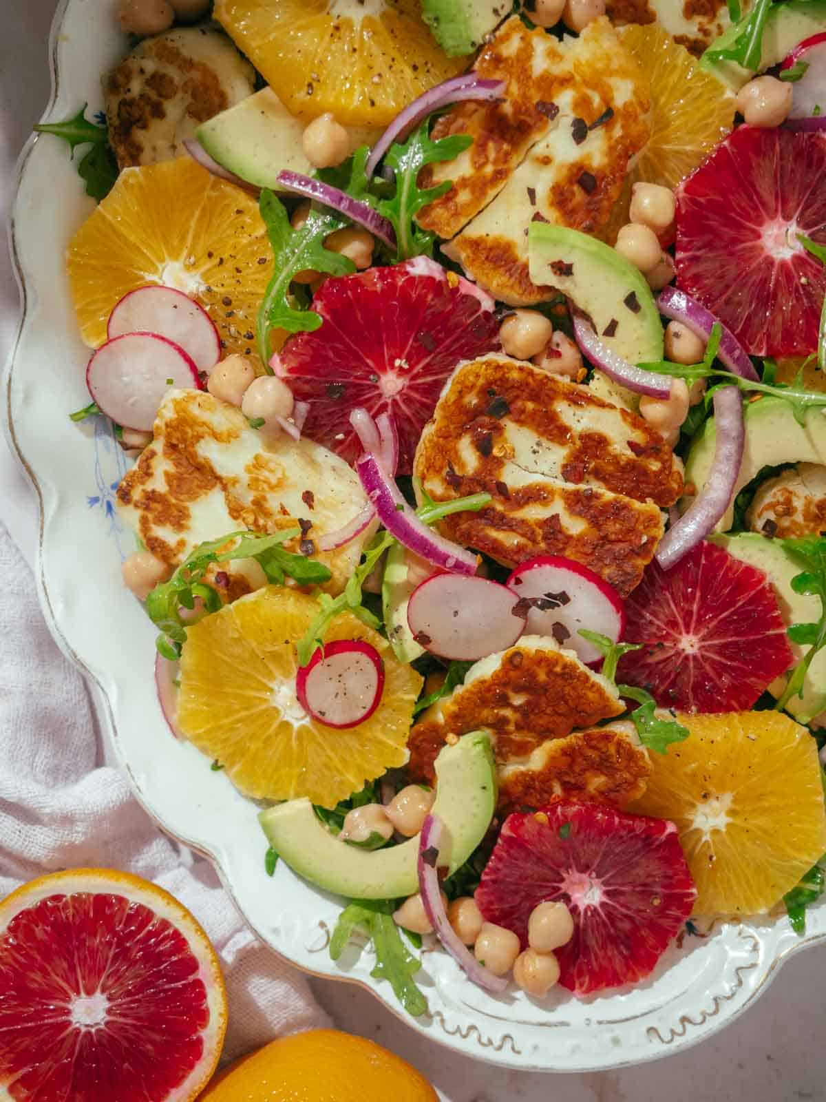 Close-up look of the Halloumi salad topped with navel and blood oranges.
